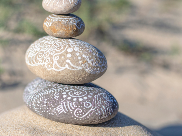 painted pebbles balancing
