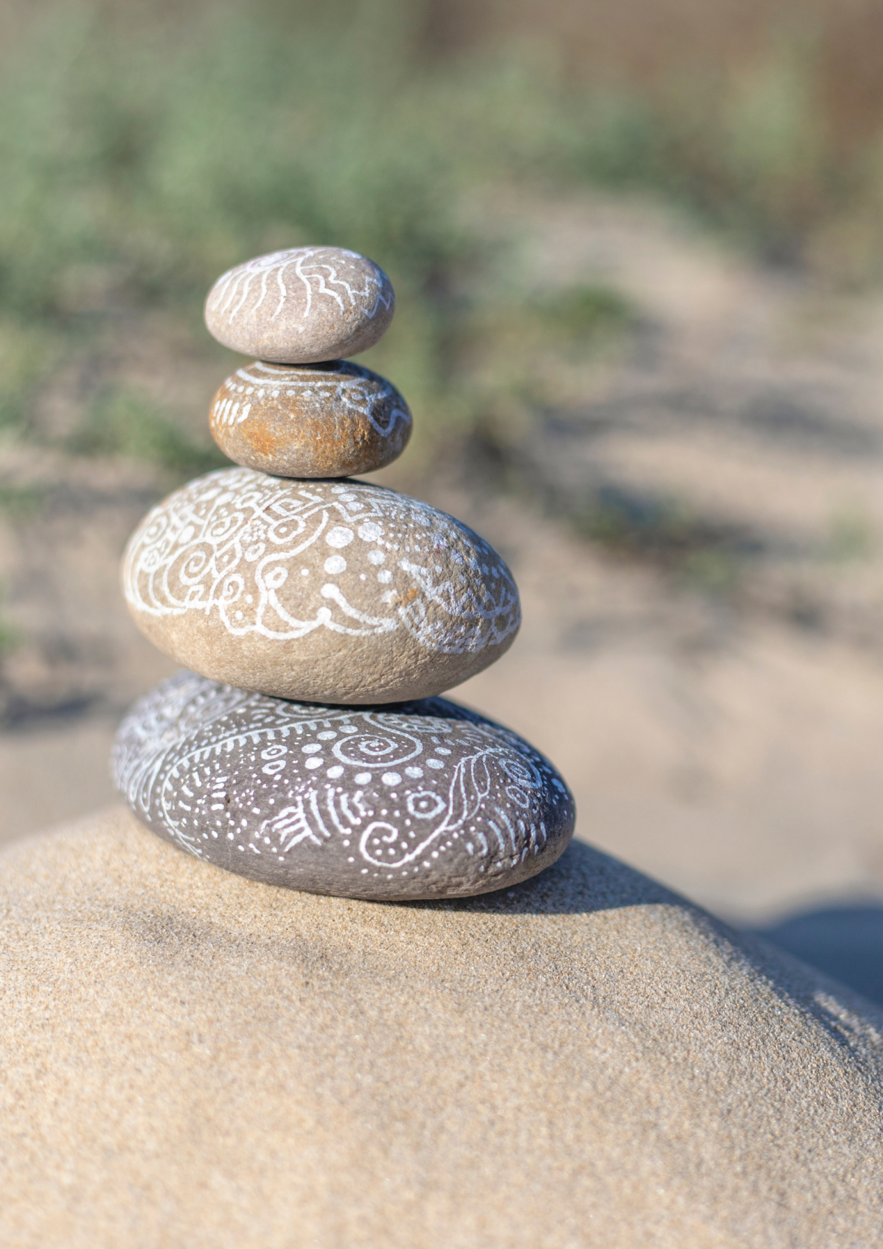 painted pebbles balancing